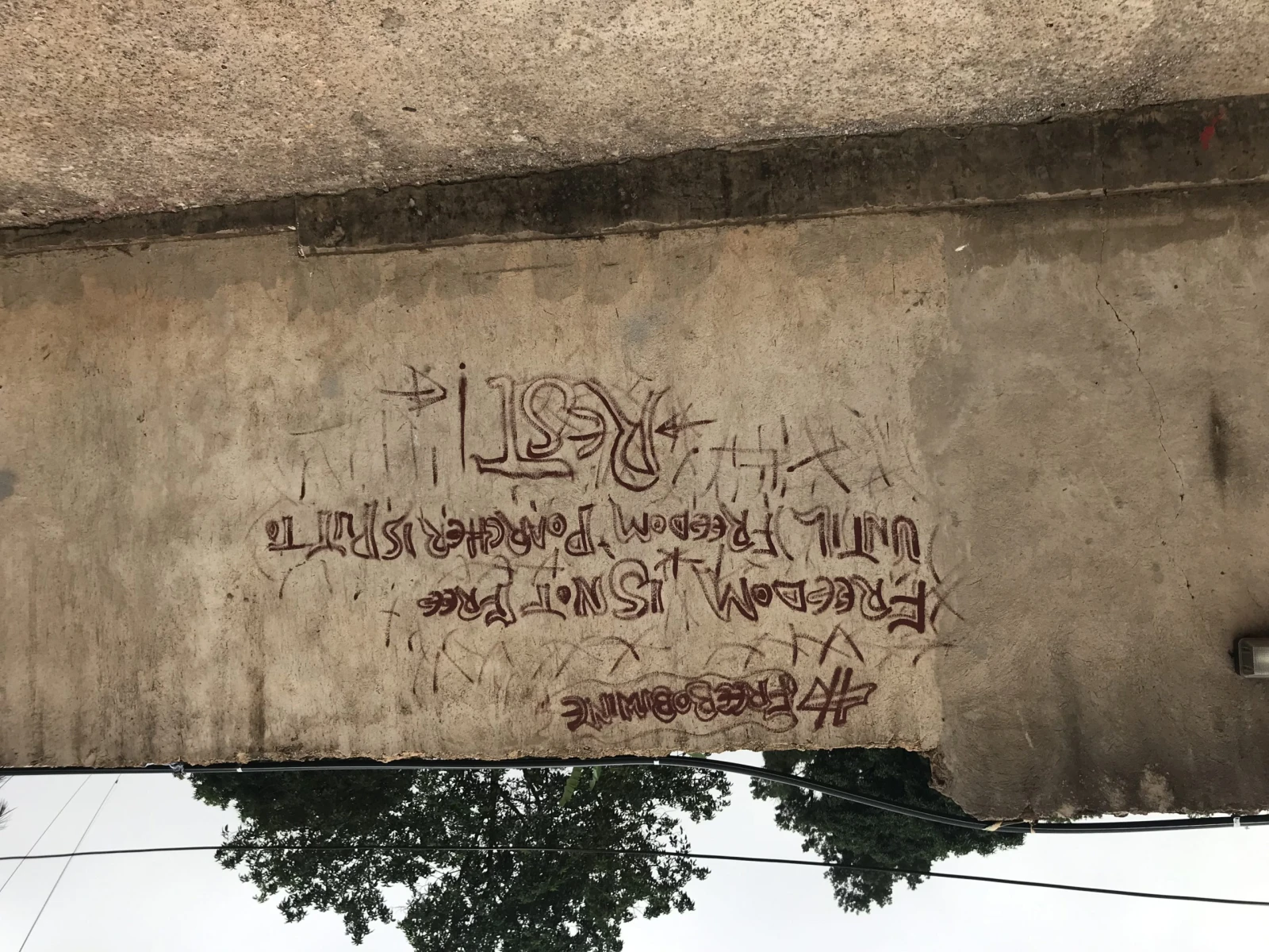 Un graffiti #freebobiwine quartier de Kamwokya